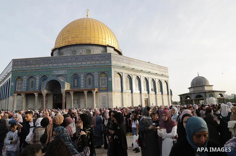 Palestinian Muslim worshipers perform the Eid al-Fitr prayer celebrating the end of the holy Muslim fasting month of Ramadan at the Al-Aqsa mosques compound in old Jerusalem on May 02, 2022. Photo by Jeries Bssier