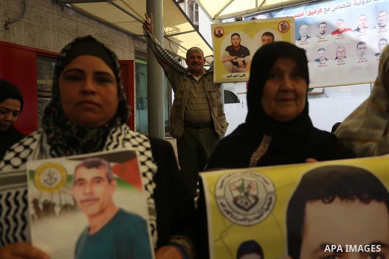 Palestinians take part in a protest in solidarity with prisoners in Israeli Jails in front of Red Cross office on May 9, 2022. The occupation stalls in providing treatment for prisoners, including the deliberate indiffer...