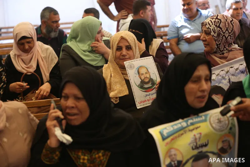 Palestinians take part in a protest in solidarity with prisoners in Israeli Jails in front of Red Cross office on May 9, 2022. The occupation stalls in providing treatment for prisoners, including the deliberate indiffer...