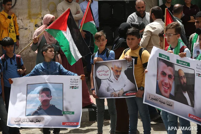 Palestinian students take part in a protest in support of Yahya Sinwar, Hamas' political chief, in front of his office in Gaza city, on May 9, 2022. Israeli officials have reportedly indirectly warned the leader of the H...