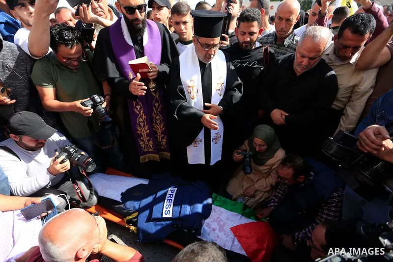 Mourners carry the body of Al Jazeera reporter Shireen Abu Akleh, who was killed by Israeli army gunfire during an Israeli raid, during her funeral in West Bank city of Jenin on May 11, 2022. Israeli military said Abu Ak...