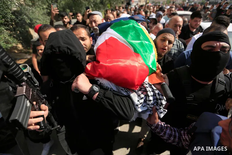 Mourners carry the body of Al Jazeera reporter Shireen Abu Akleh, who was killed by Israeli army gunfire during an Israeli raid, during her funeral in West Bank city of Jenin on May 11, 2022. Israeli military said Abu Ak...