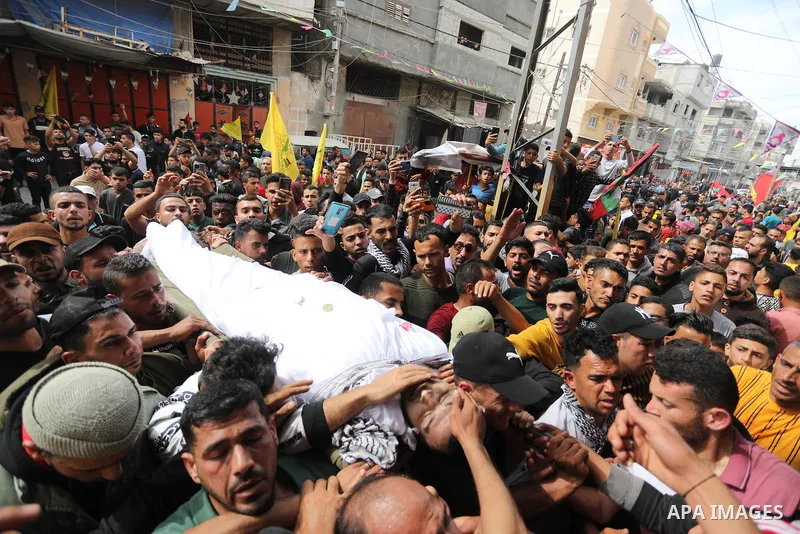 Mourners carry the body of Palestinian Mahmoud Aram who was shot killed by Israeli forces near a military checkpoint to the south of Tulkarem on Sunday, during his funeral in Khan Younis in the southern of Gaza strip, on...