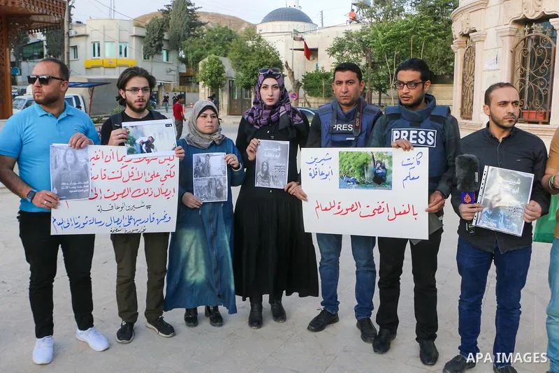 Syrians hold posters displaying veteran Al Jazeera journalist Shireen Abu Aqleh, who was, according to the network, shot dead by Israeli troops as she covered a raid on the West Bank's Jenin refugee camp on May 11, 2022,...