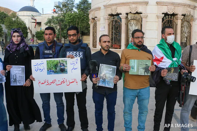 Syrians hold posters displaying veteran Al Jazeera journalist Shireen Abu Aqleh, who was, according to the network, shot dead by Israeli troops as she covered a raid on the West Bank's Jenin refugee camp on May 11, 2022,...