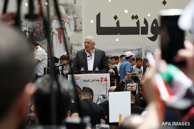 Palestinians wave national flags as they march in a rally marking the 74th anniversary of the "Nakba" or "catastrophe", in the West Bank city of Ramallah, on May 15, 2022. Each year Palestinians commemorate the "Nakba" o...