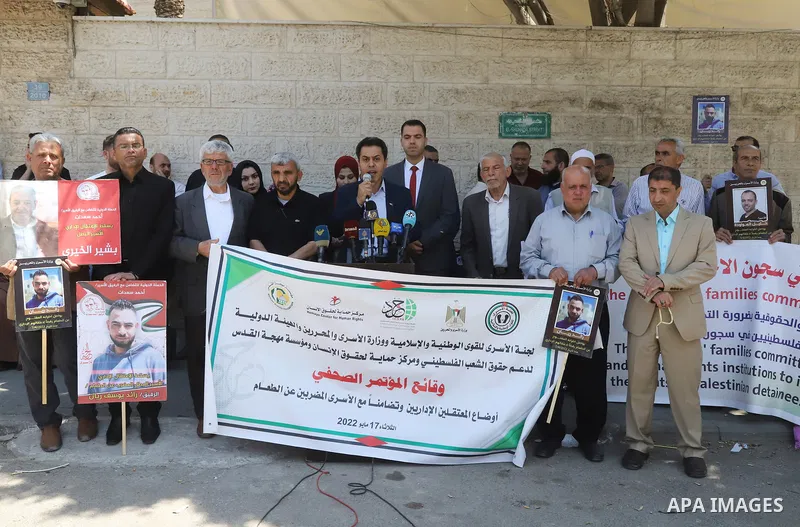 Palestinians take part in a protest in solidarity with prisoners in Israeli Jails in front of Red Cross office on May 17, 2022. More than 450 Palestinian detainees have been refusing to show up for their military court h...