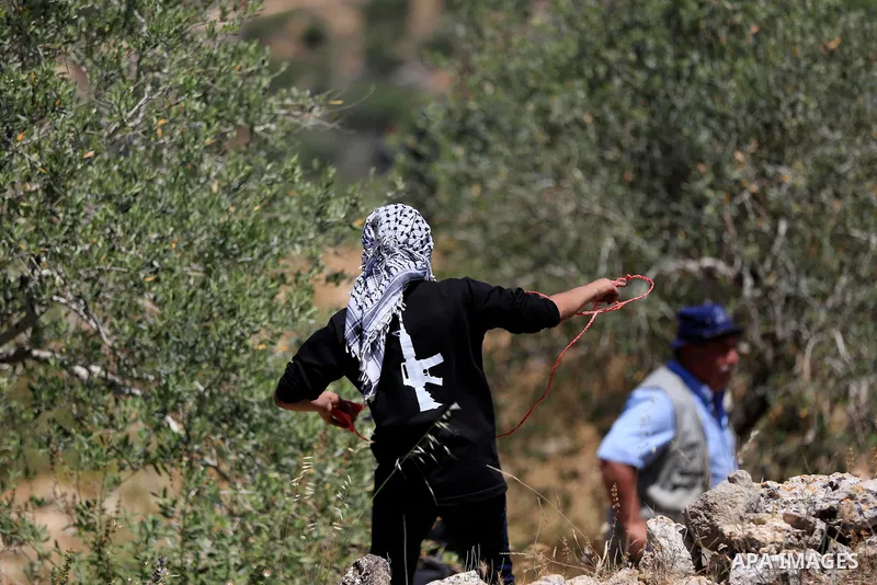 Palestinian protesters clash with Isareli forces during a demonstration against settlements in the village of Beita in the West Bank on May 20, 2022. Photo by Shadi Jarar'ah