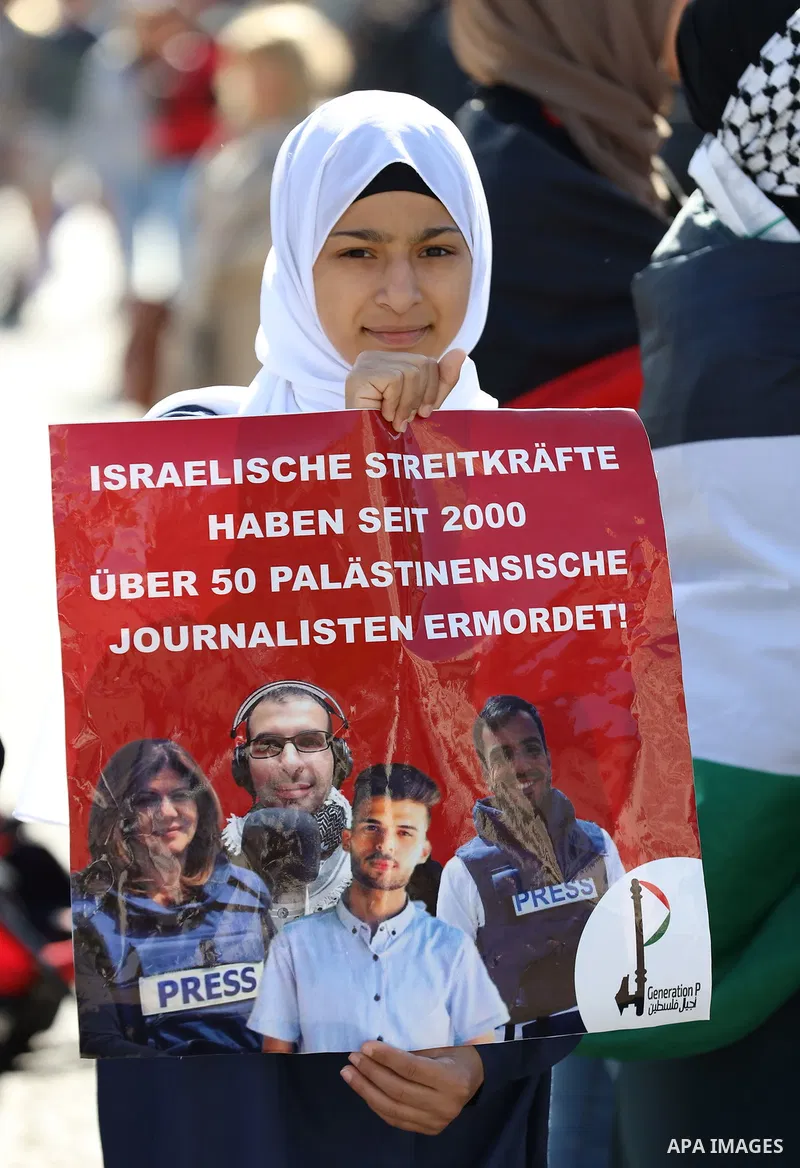 Foreign activists and Palestinians take part in a protest following the death of veteran Al Jazeera journalist Shireen Abu Aqleh, shot dead by Israeli troops as she covered a raid on the West Bank's Jenin refugee campin...