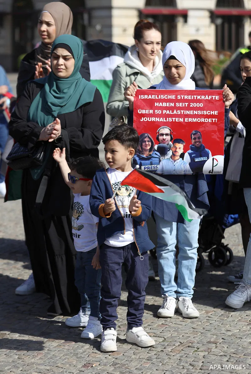 Foreign activists and Palestinians take part in a protest following the death of veteran Al Jazeera journalist Shireen Abu Aqleh, shot dead by Israeli troops as she covered a raid on the West Bank's Jenin refugee campin...