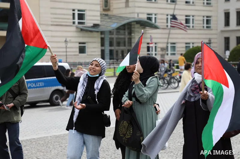 Foreign activists and Palestinians take part in a protest following the death of veteran Al Jazeera journalist Shireen Abu Aqleh, shot dead by Israeli troops as she covered a raid on the West Bank's Jenin refugee campin...