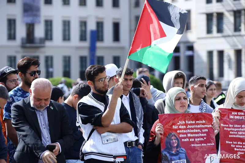 Foreign activists and Palestinians take part in a protest following the death of veteran Al Jazeera journalist Shireen Abu Aqleh, shot dead by Israeli troops as she covered a raid on the West Bank's Jenin refugee campin...