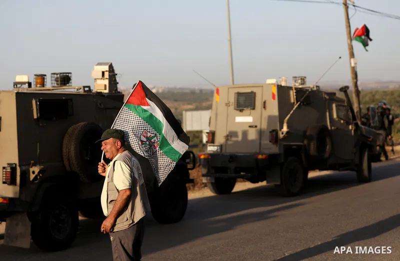 Palestinians confront Israeli security forces after an attempt by Israeli settlers to remove Palestinian flag, in Ezbet el-Tabib village east of the city of Qalqilya on May 31, 2022. Photo by Stringer