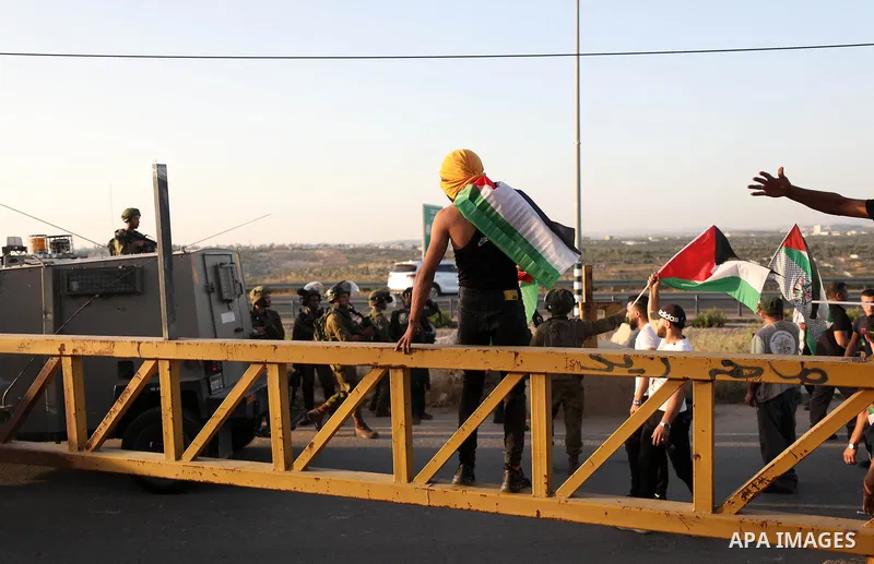 Palestinians confront Israeli security forces after an attempt by Israeli settlers to remove Palestinian flag, in Ezbet el-Tabib village east of the city of Qalqilya on May 31, 2022. Photo by Stringer