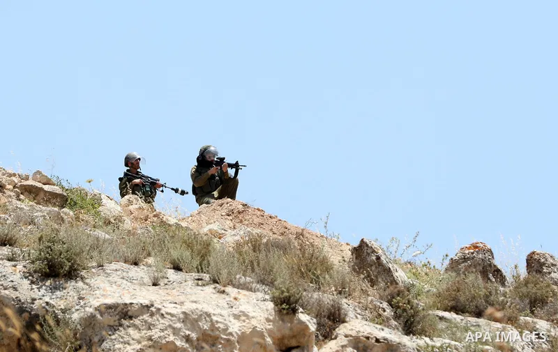 Israeli forces take position during clashes with Palestinian protesters during a demonstration against settlements in the village of Beit Dajan, near the West Bank city of Nablus on June 3, 2022. Photo by Stringer