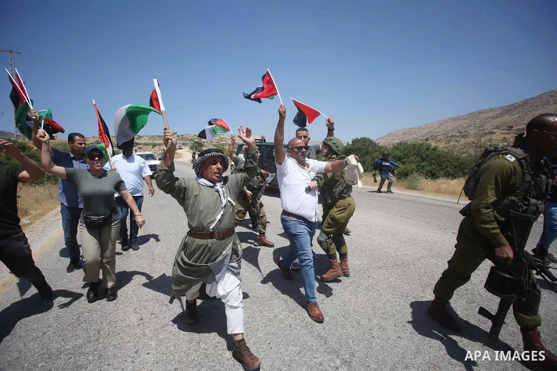 Israeli soldiers argue with Palestinian demonstrators during a protest against Israeli settlements in Jordan Valley, at Tayasir checkpoint, near Tubas in the West Bank, on June 6, 2022. Photo by Shadi Jarar'ah