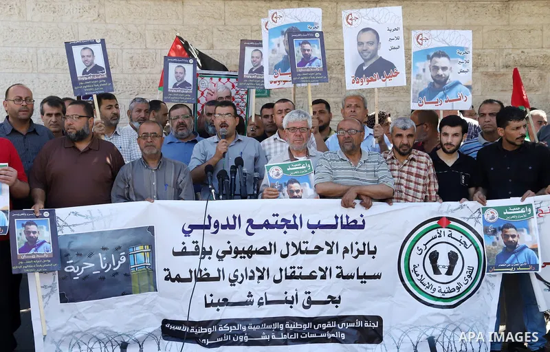 Palestinians take part in a protest in solidarity with prisoners on hunger strike in Israeli jails, in front of Red cross office in Gaza City on June 13, 2022. Two Palestinian administrative detainees in Israeli prisons...