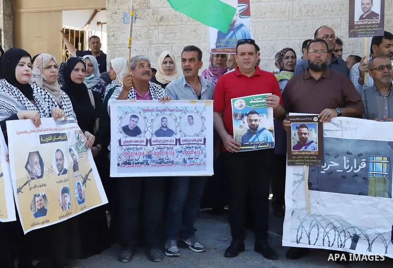 Palestinians take part in a protest in solidarity with prisoners on hunger strike in Israeli jails, in front of Red cross office in Gaza City on June 13, 2022. Two Palestinian administrative detainees in Israeli prisons...
