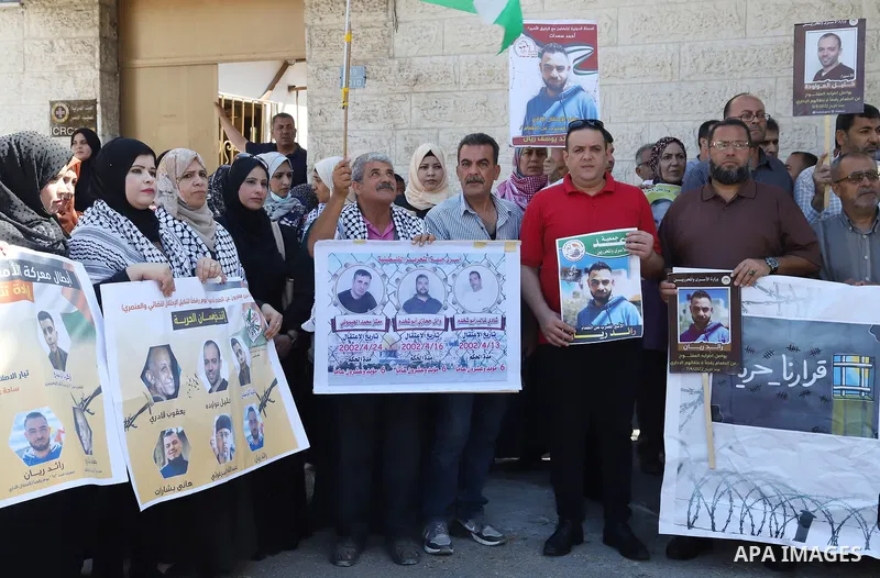 Palestinians take part in a protest in solidarity with prisoners on hunger strike in Israeli jails, in front of Red cross office in Gaza City on June 13, 2022. Two Palestinian administrative detainees in Israeli prisons...