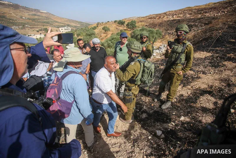 Israeli forces prevent a protest against settlement by Palestinian and foreign activists near outpost of Givat Ronen in Burin village, near the West Bank city of Nablus, on June 17, 2022. Photo by Shadi Jarar'ah