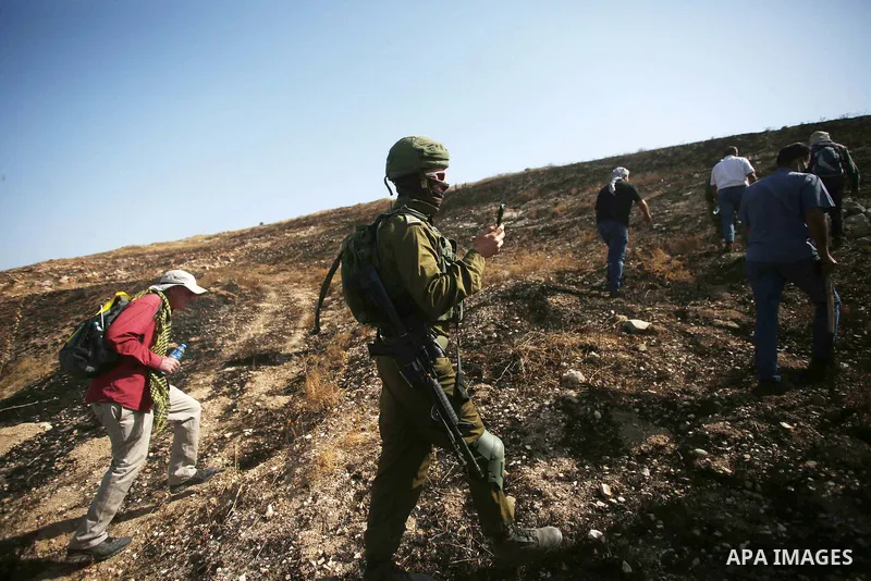 Israeli forces prevent a protest against settlement by Palestinian and foreign activists near outpost of Givat Ronen in Burin village, near the West Bank city of Nablus, on June 17, 2022. Photo by Shadi Jarar'ah