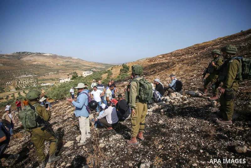 Israeli forces prevent a protest against settlement by Palestinian and foreign activists near outpost of Givat Ronen in Burin village, near the West Bank city of Nablus, on June 17, 2022. Photo by Shadi Jarar'ah