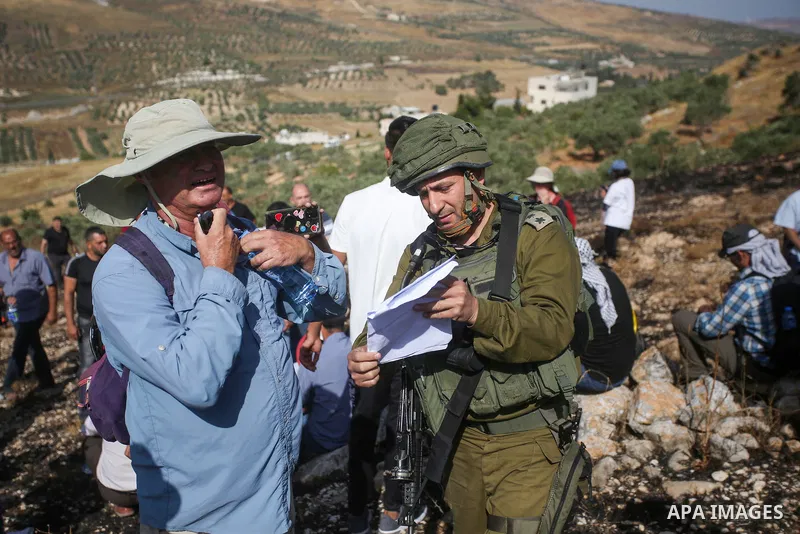 Israeli forces prevent a protest against settlement by Palestinian and foreign activists near outpost of Givat Ronen in Burin village, near the West Bank city of Nablus, on June 17, 2022. Photo by Shadi Jarar'ah