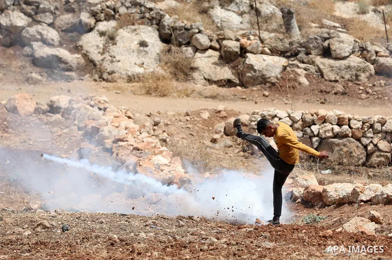 Palestinian protesters clash with Israeli forces during a demonstration against settlements in the village of Beit Dajan, near the West Bank city of Nablus on June 17, 2022. Photo by Wajed Nobani