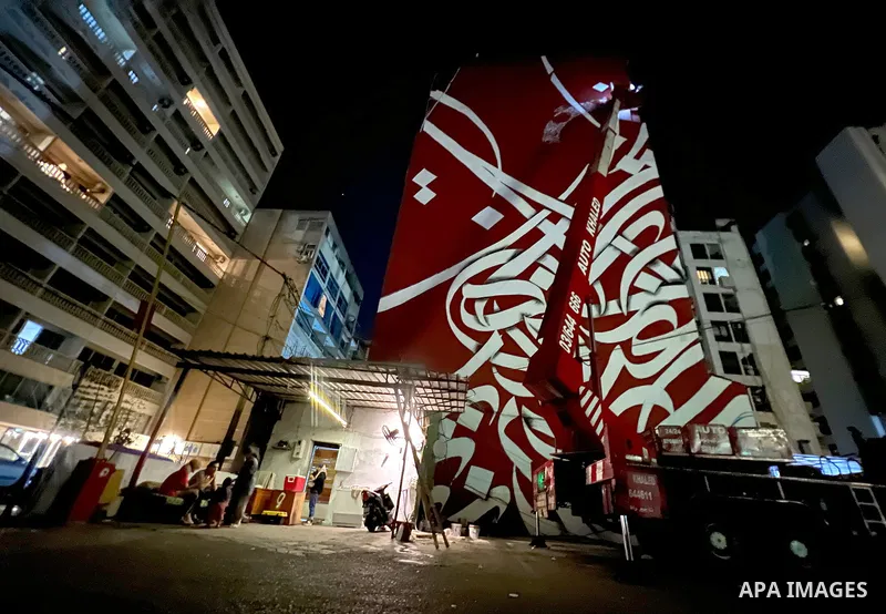 Palestinian artist Bilal Khaled draws on a wall a graffiti mural in Beirut on June 19, 2022. Photo by Nidal Al-Wahidi