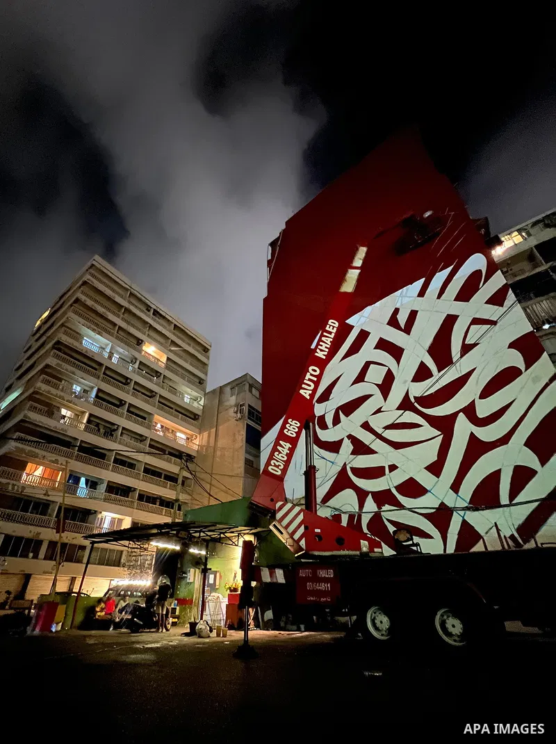 Palestinian artist Bilal Khaled draws on a wall a graffiti mural in Beirut on June 19, 2022. Photo by Nidal Al-Wahidi