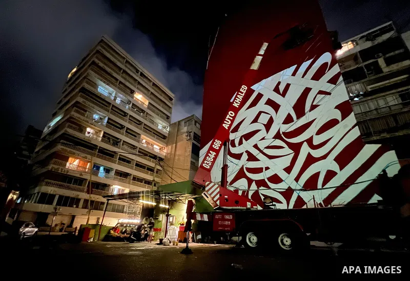 Palestinian artist Bilal Khaled draws on a wall a graffiti mural in Beirut on June 19, 2022. Photo by Nidal Al-Wahidi