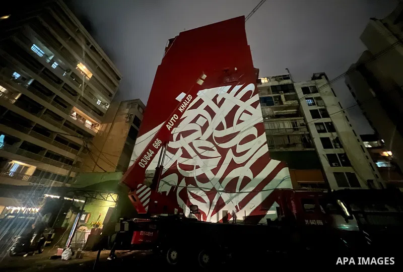 Palestinian artist Bilal Khaled draws on a wall a graffiti mural in Beirut on June 19, 2022. Photo by Nidal Al-Wahidi