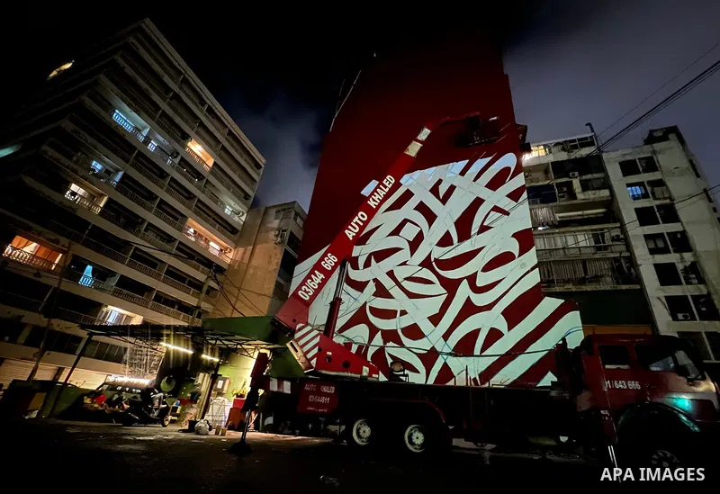 Palestinian artist Bilal Khaled draws on a wall a graffiti mural in Beirut on June 19, 2022. Photo by Nidal Al-Wahidi
