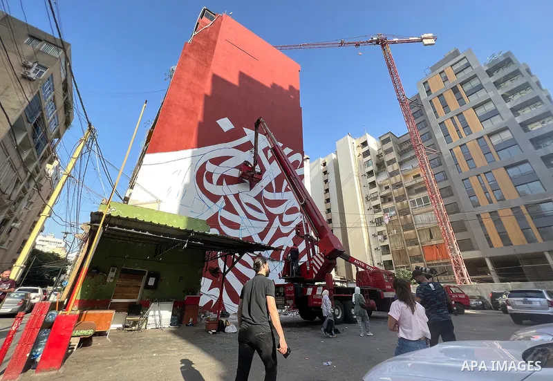 Palestinian artist Bilal Khaled draws on a wall a graffiti mural in Beirut on June 19, 2022. Photo by Nidal Al-Wahidi