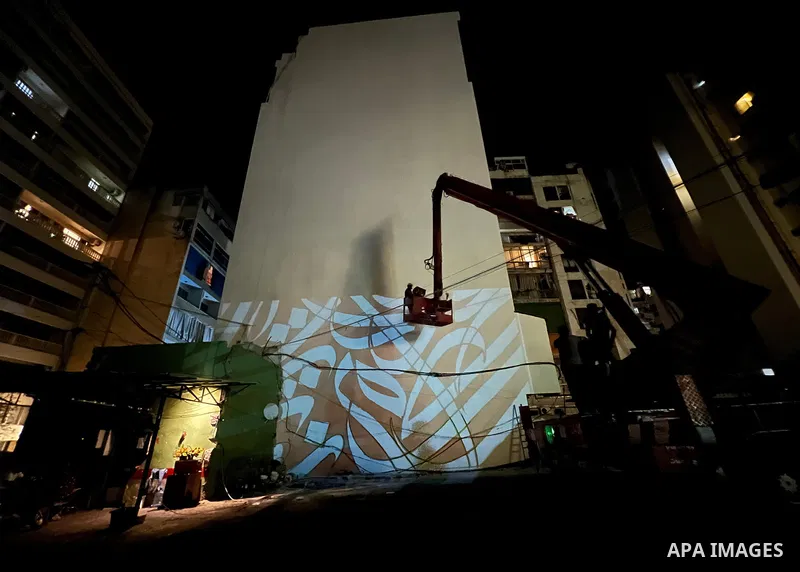 Palestinian artist Bilal Khaled draws on a wall a graffiti mural in Beirut on June 19, 2022. Photo by Nidal Al-Wahidi