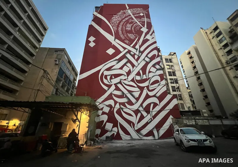 Palestinian artist Bilal Khaled draws on a wall a graffiti mural in Beirut on June 19, 2022. Photo by Nidal Al-Wahidi