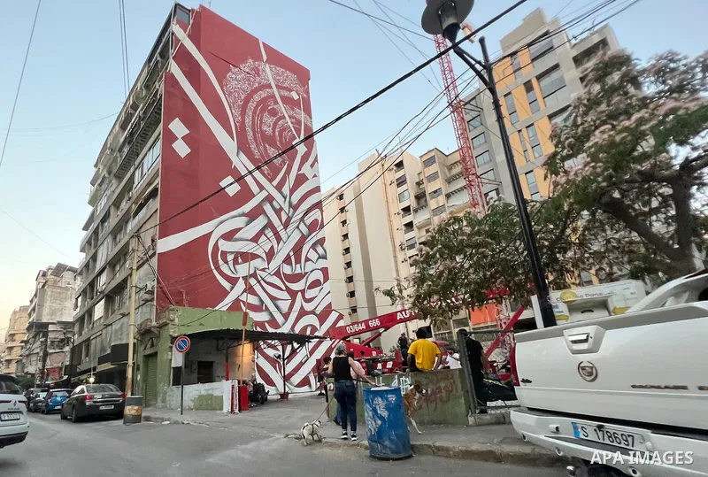 Palestinian artist Bilal Khaled draws on a wall a graffiti mural in Beirut on June 19, 2022. Photo by Nidal Al-Wahidi