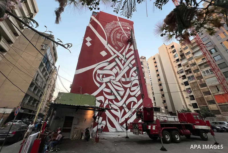 Palestinian artist Bilal Khaled draws on a wall a graffiti mural in Beirut on June 19, 2022. Photo by Nidal Al-Wahidi
