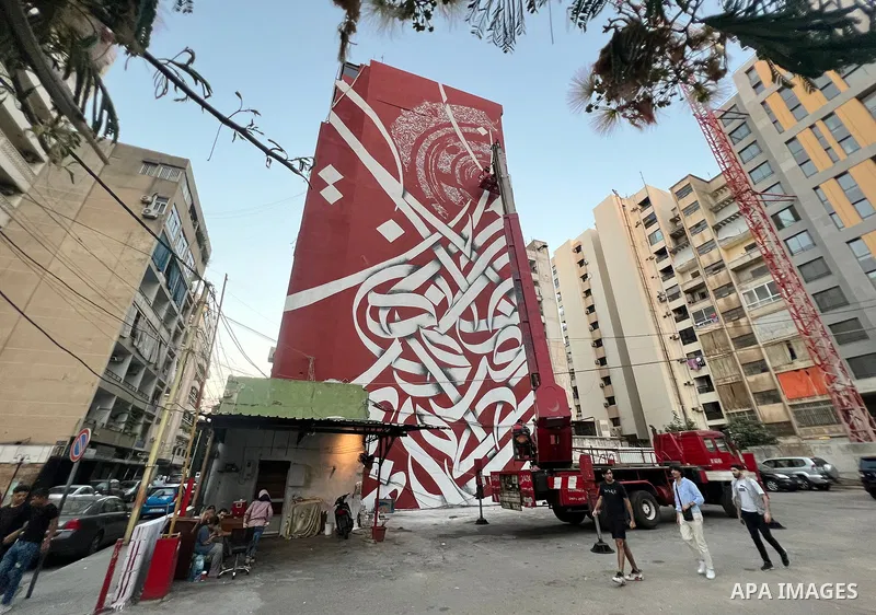 Palestinian artist Bilal Khaled draws on a wall a graffiti mural in Beirut on June 19, 2022. Photo by Nidal Al-Wahidi