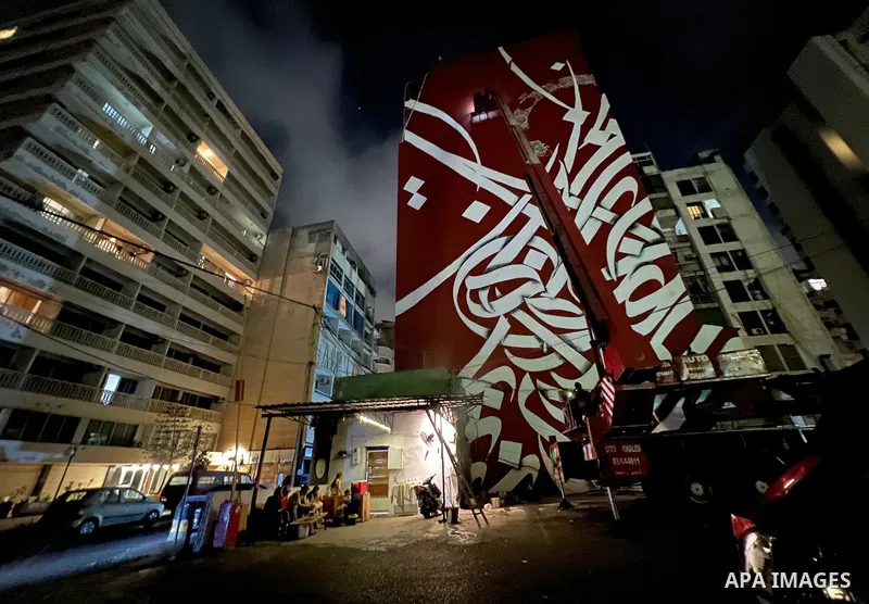 Palestinian artist Bilal Khaled draws on a wall a graffiti mural in Beirut on June 19, 2022. Photo by Nidal Al-Wahidi