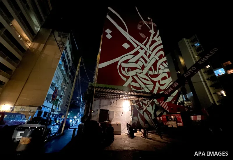 Palestinian artist Bilal Khaled draws on a wall a graffiti mural in Beirut on June 19, 2022. Photo by Nidal Al-Wahidi