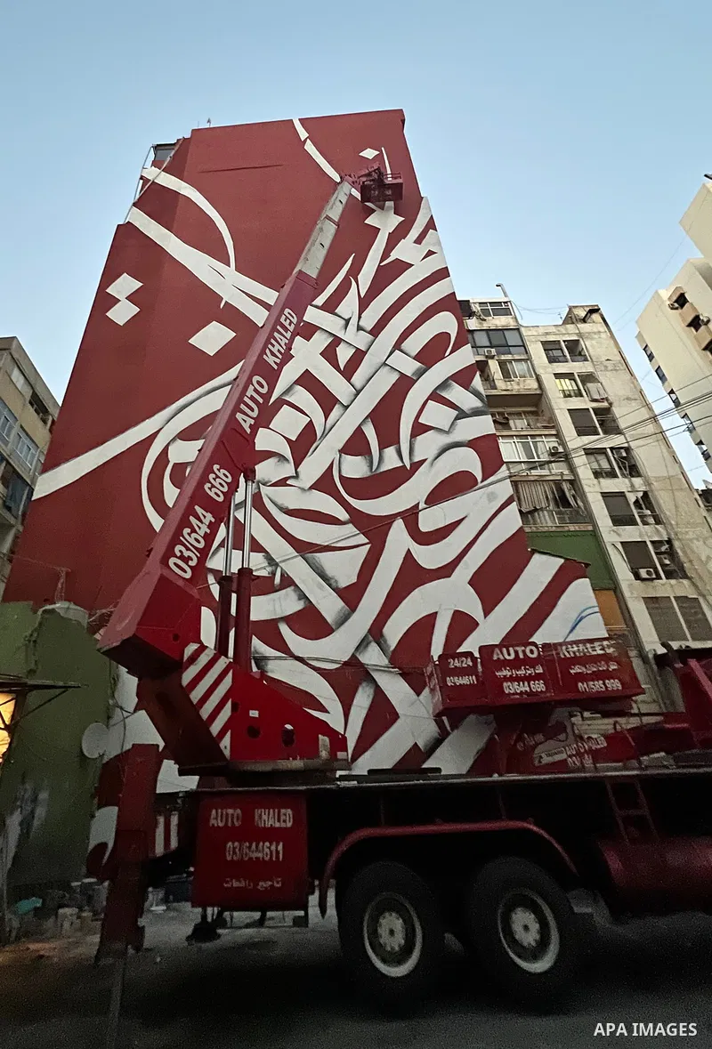 Palestinian artist Bilal Khaled draws on a wall a graffiti mural in Beirut on June 19, 2022. Photo by Nidal Al-Wahidi