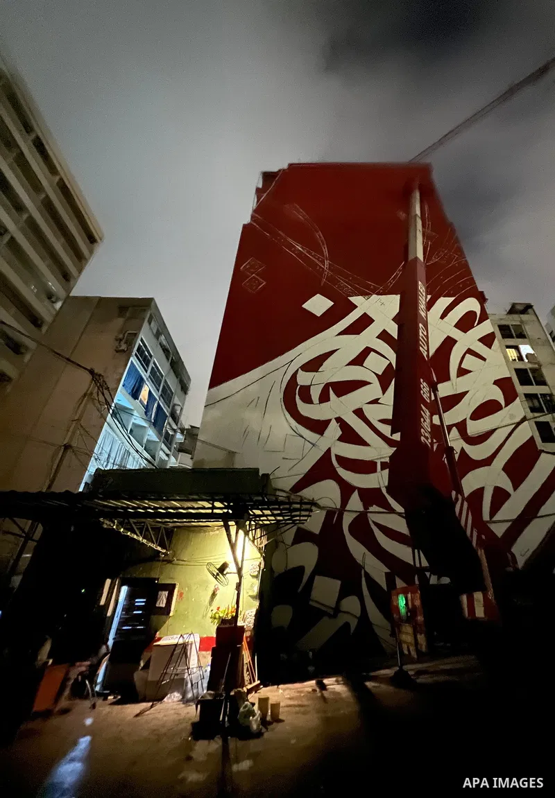 Palestinian artist Bilal Khaled draws on a wall a graffiti mural in Beirut on June 19, 2022. Photo by Nidal Al-Wahidi