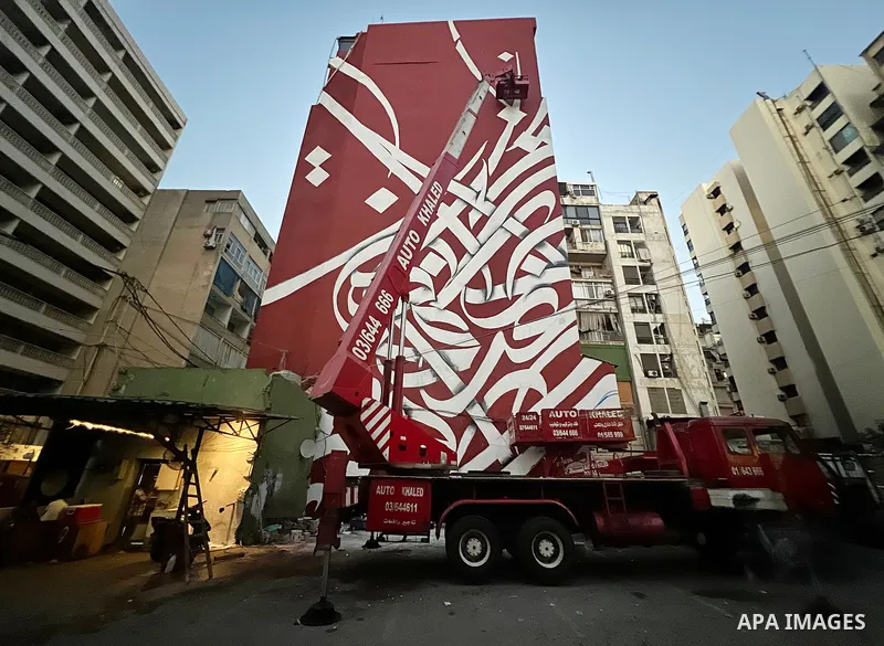 Palestinian artist Bilal Khaled draws on a wall a graffiti mural in Beirut on June 19, 2022. Photo by Nidal Al-Wahidi