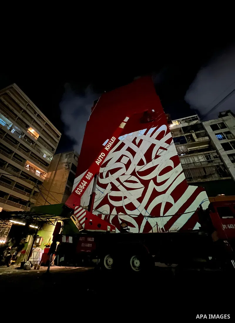 Palestinian artist Bilal Khaled draws on a wall a graffiti mural in Beirut on June 19, 2022. Photo by Nidal Al-Wahidi