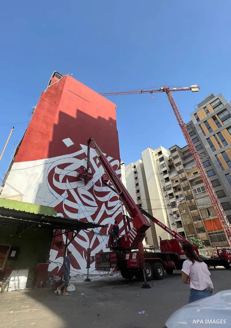 Palestinian artist Bilal Khaled draws on a wall a graffiti mural in Beirut on June 19, 2022. Photo by Nidal Al-Wahidi