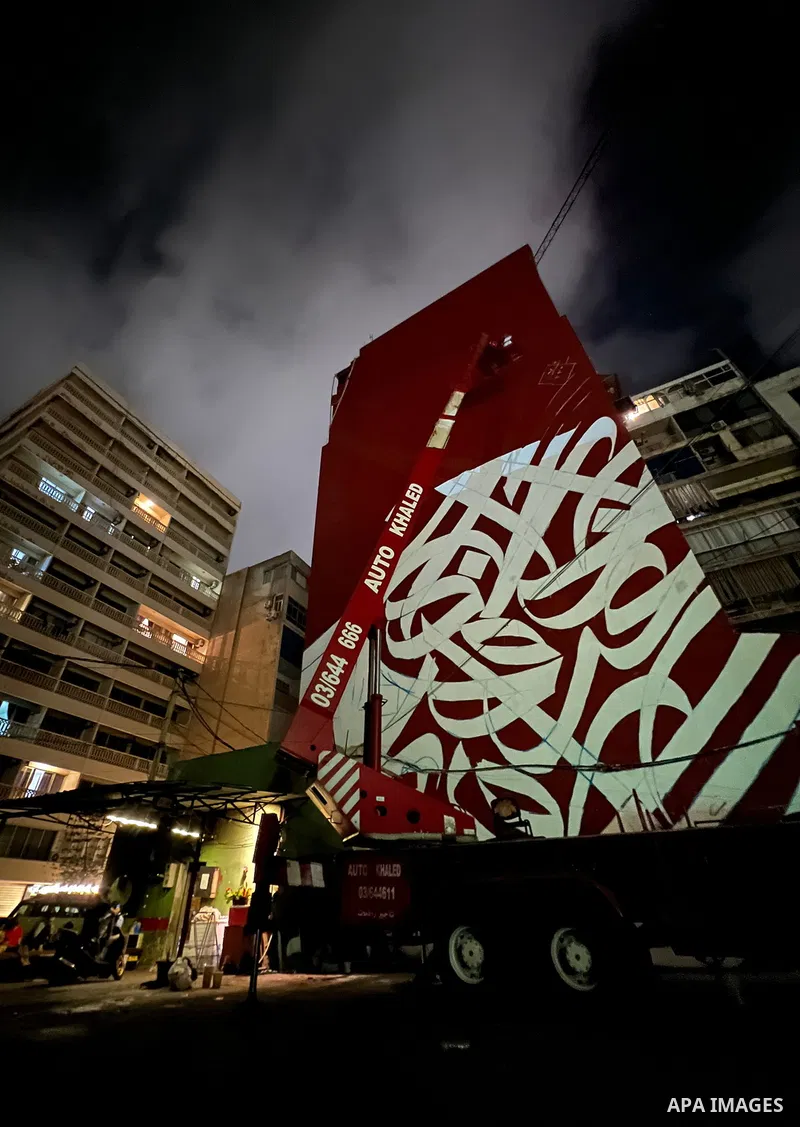 Palestinian artist Bilal Khaled draws on a wall a graffiti mural in Beirut on June 19, 2022. Photo by Nidal Al-Wahidi