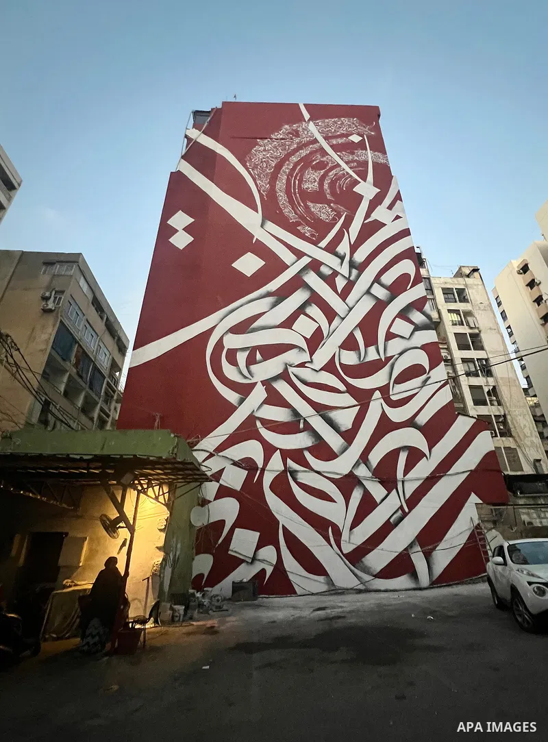 Palestinian artist Bilal Khaled draws on a wall a graffiti mural in Beirut on June 19, 2022. Photo by Nidal Al-Wahidi