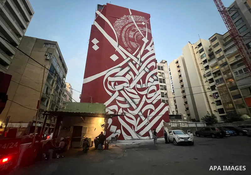 Palestinian artist Bilal Khaled draws on a wall a graffiti mural in Beirut on June 19, 2022. Photo by Nidal Al-Wahidi