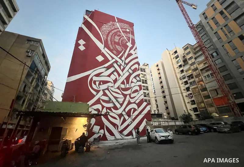 Palestinian artist Bilal Khaled draws on a wall a graffiti mural in Beirut on June 19, 2022. Photo by Nidal Al-Wahidi